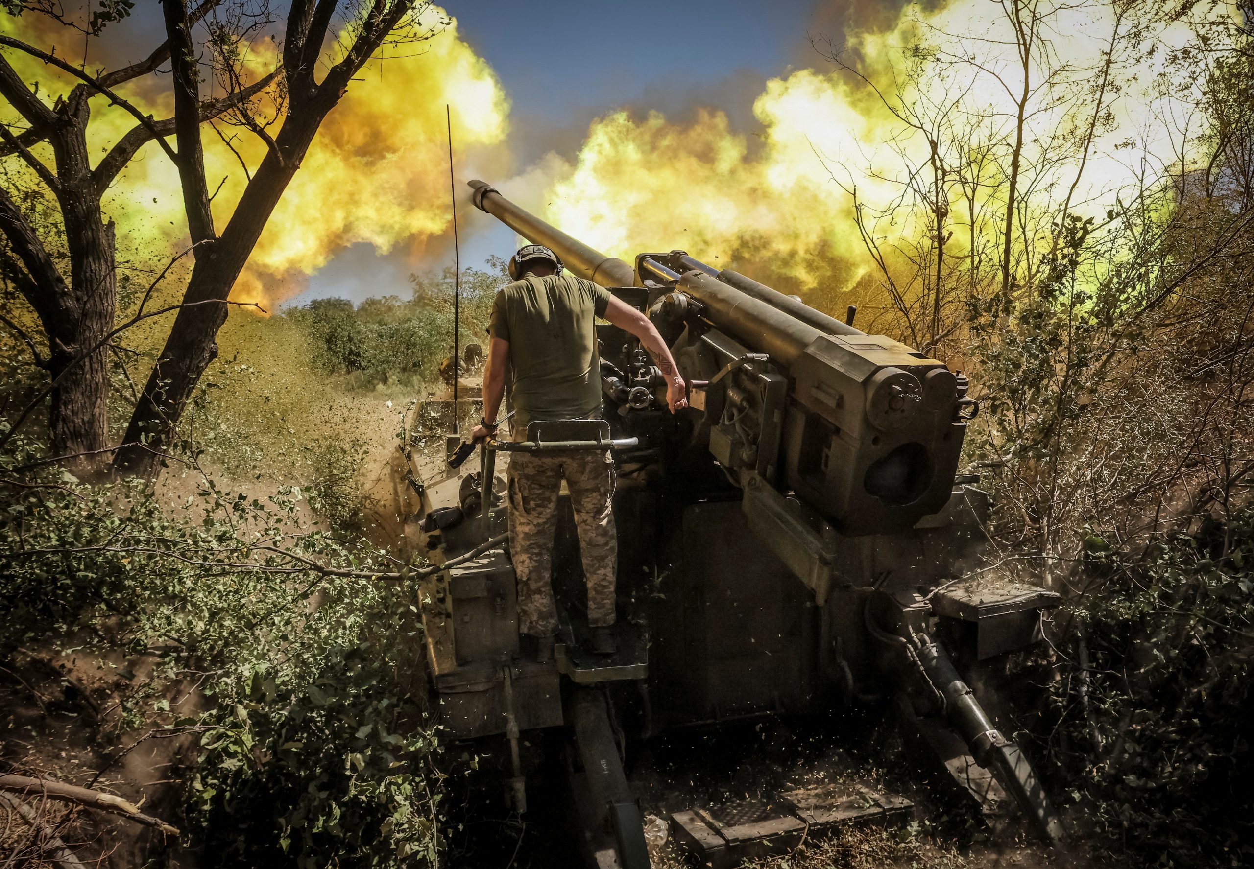 Ukrainian servicemen fire a self-propelled howitzer towards Russian troops at a frontline near the town of Chasiv Yar