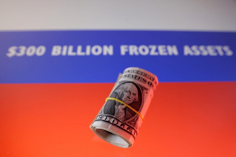 Illustration shows U.S. dollar banknotes and Russian flag