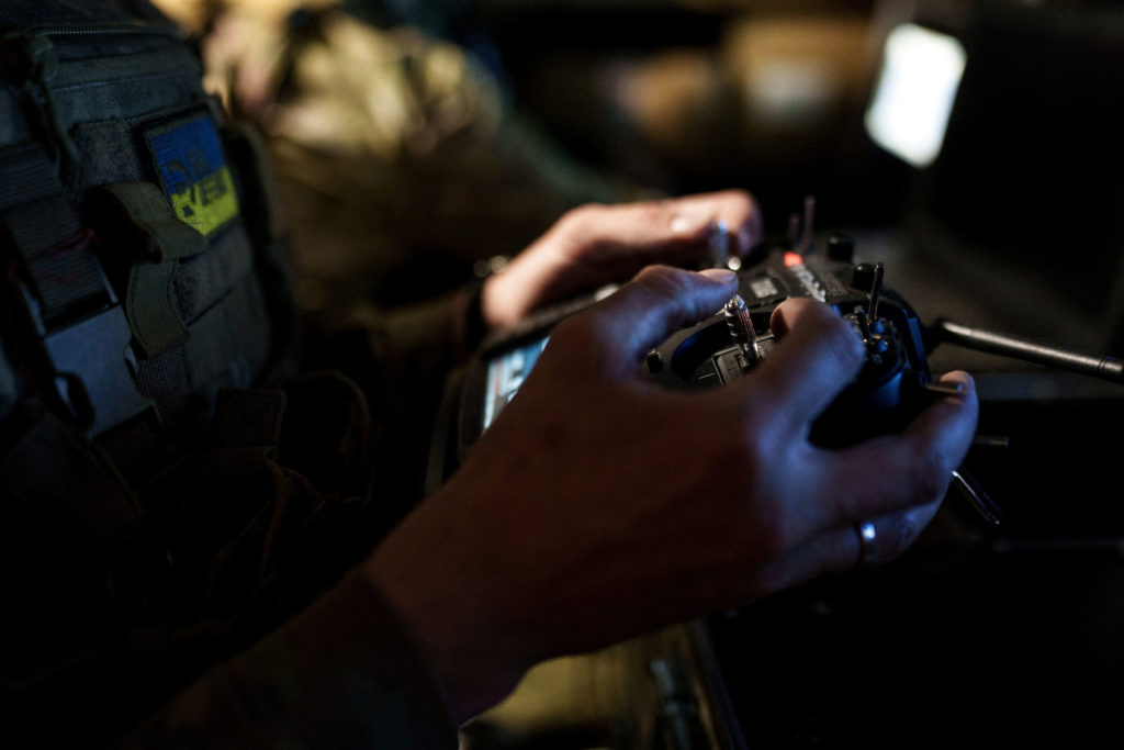 FILE PHOTO: Ukrainian serviceman controls a heavy combat drone while it flies over positions of Russian troops in Donetsk region